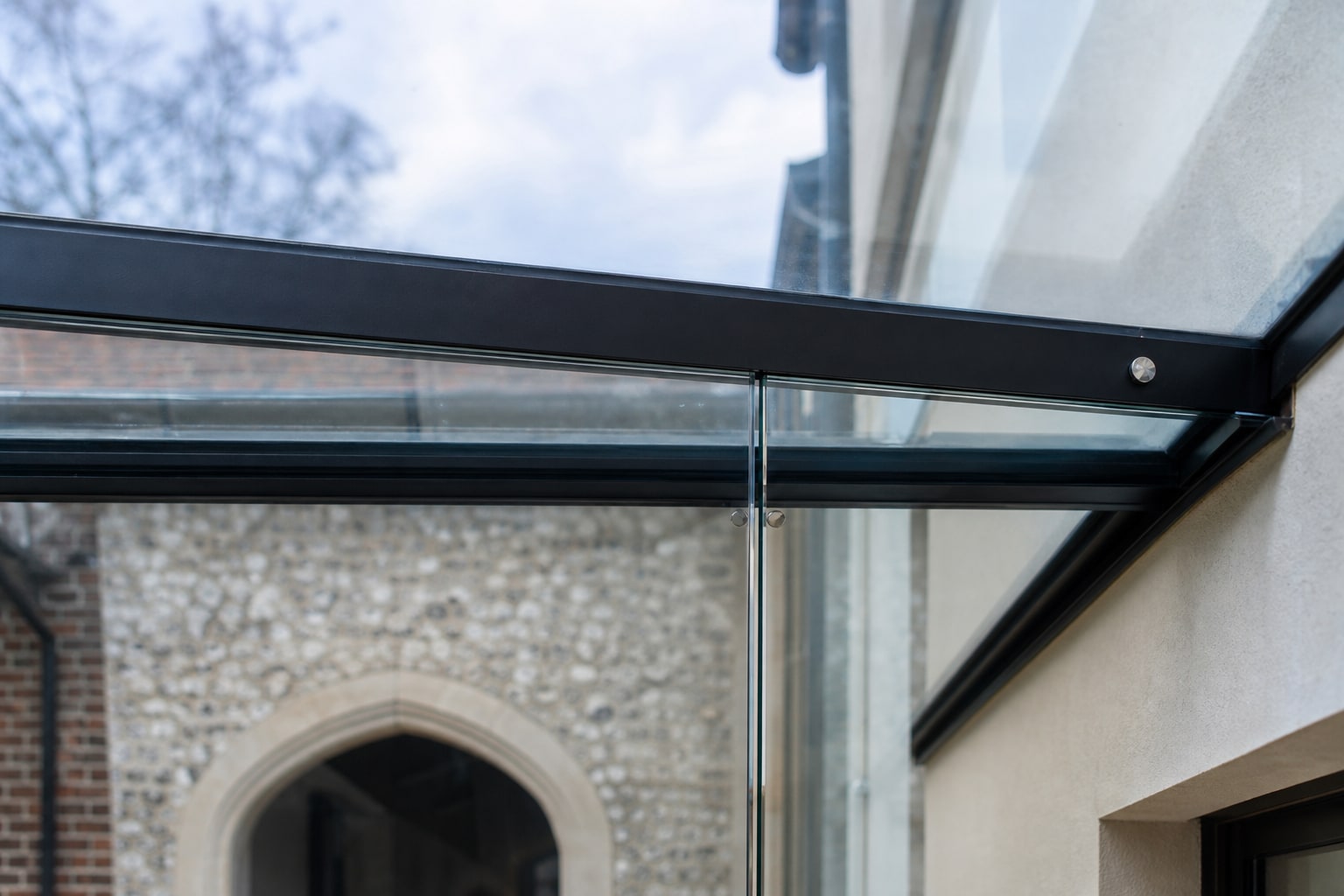 Glass roof panel joint and steel edge detail