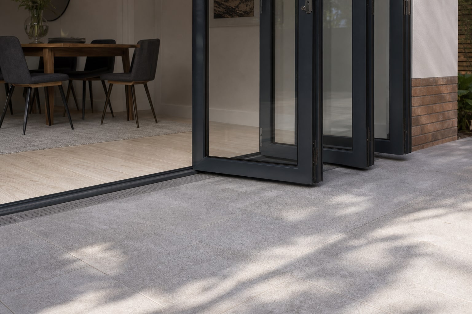 Flush threshold track meeting the patio tiles